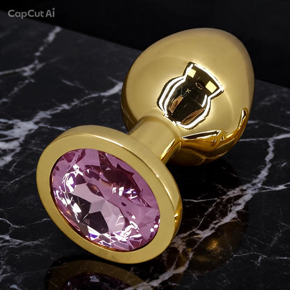 Plug anal de acero dorado con joya rosa - presentación elegante